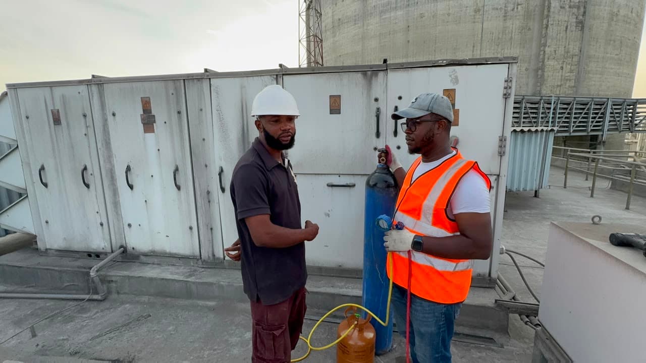 Helmont technicians reviewing work on an industrial rooftop